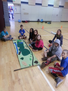 Kids learning what a golf hole looks like - Options School